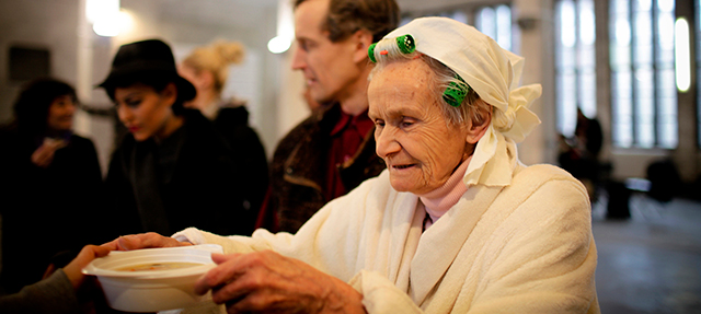 Photo: Older woman In soup kitchen line