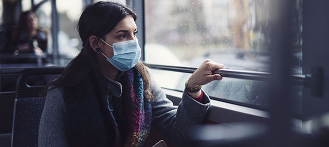 photo - Woman Wearing Mask on Bus