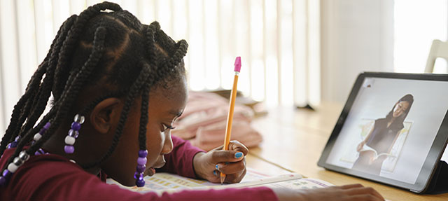 photo - An Elementary School Student Working at Home, Using a Tablet