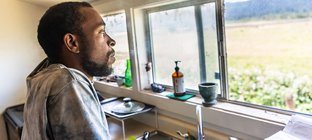 photo - Man at Kitchen Sink Looking Out Window