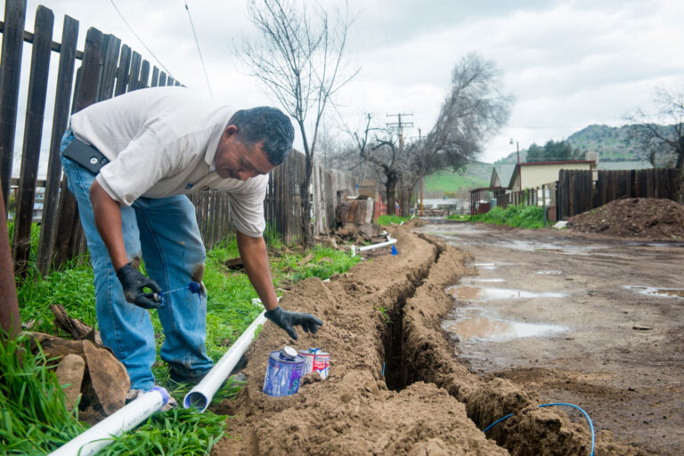 photo - Man Installing Water Pipeline to Home in East Porterville, California - pixel-ca-dwr-FL_Porterville-5307