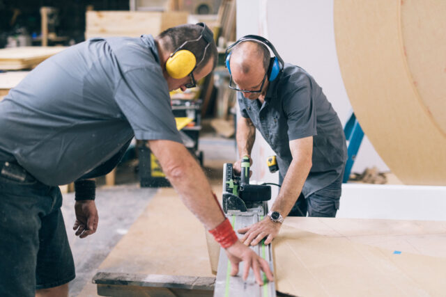 photo - Carpenters Using an Electric Saw To Cut Wood