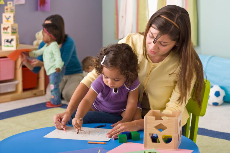 photo - Child Care Worker Drawing with Little Girl