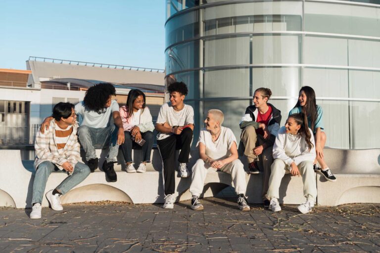 photo - Young People in Front of City Building